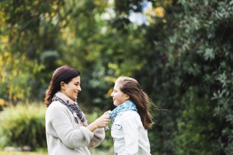 Mother adjusting daughter's scar
