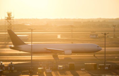 Airplane on runway at sunset