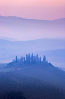 Trees on hills at sunset in Tuscany, Italy
