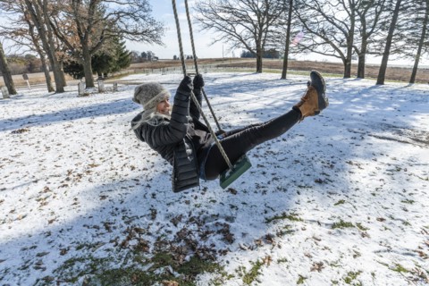 Woman on swing in snow