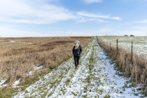 Woman walking in snowy field