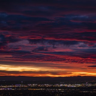 Cityscape under dramatic sky at sunset