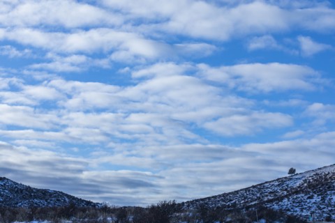 Snowy hills under cloud