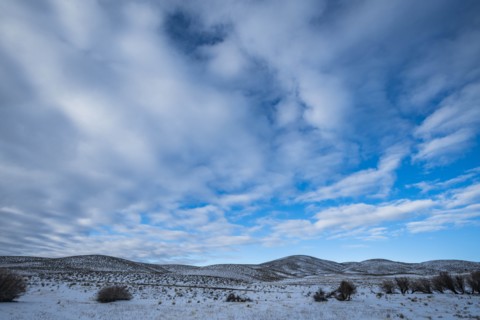 Snowy hills under cloud