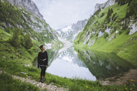 Woman by mountains and lake in Appenzell, Switzerland