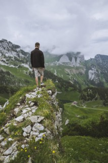 Man on rock by mountains