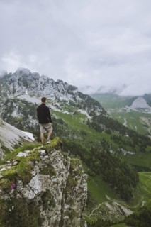Man on rock by mountains
