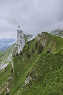 Woman sitting on mountain in Appenzell, Switzerland