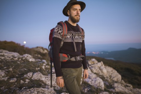 Man against mountain range at sunset