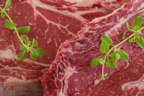 Raw steak and oregano
