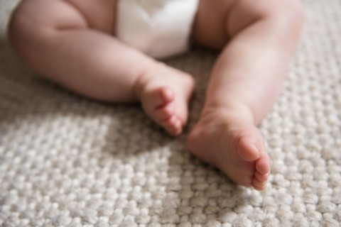 Baby's bare feet on carpet