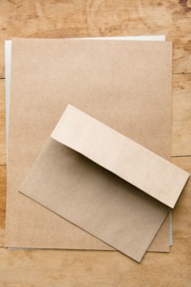 Envelope and paper on wooden table
