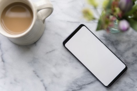 Smartphone and cup of coffee