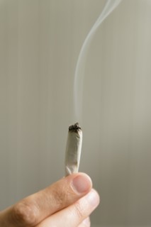 Hand of woman holding marijuana joint