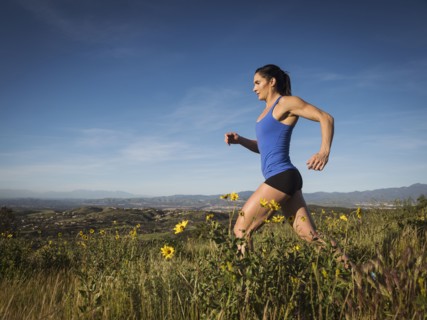 Woman jogging in meadow