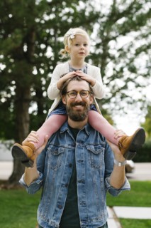 Father giving daughter piggyback ride