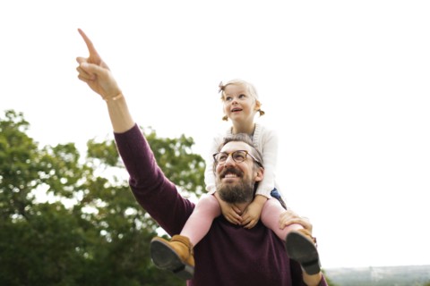 Father giving daughter piggyback ride
