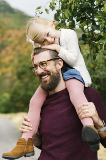 Father giving daughter piggyback ride