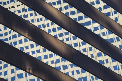 Reflections in window of skyscraper in Denver, Colorado