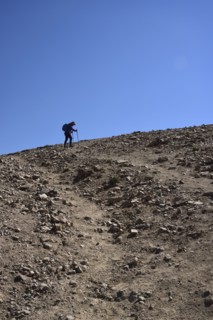 Low angle view of woman on hiking talus slope in Denver, Colorado
