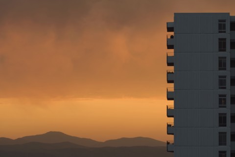 Distant wildfires and apartment building at sunset in Denver, Colorado