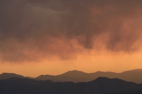 Distant wildfires and mountains at sunset in Denver, Colorado