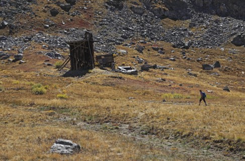 Woman hiking by abandoned mineshaft in Mayflower Gulch, Arizona