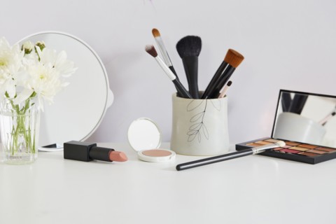Flowers and make-up on white table