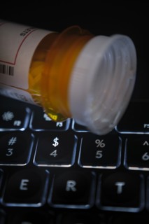Pill bottle on computer keyboard
