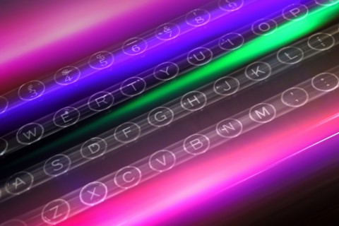 Colorful light trails over keys of typewriter