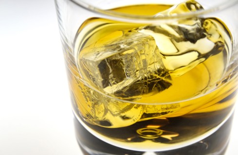 Glass of whiskey with ice cubes