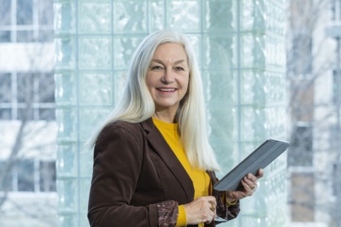 Smiling businesswoman with digital tablet in office
