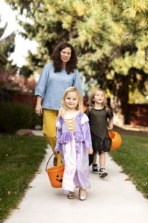 Girls in Halloween costumes with their mother