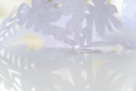 Paper snowflake on glass table