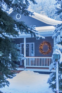 Illuminated Christmas wreath on house during winter