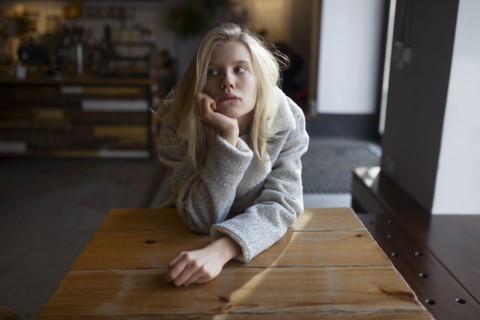 young woman sitting at cafe table
