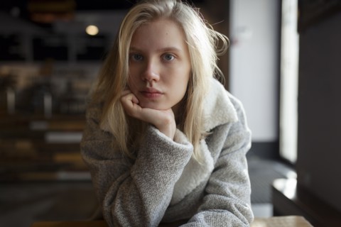young woman with wool coat in cafe