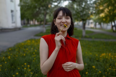 Smiling young woman holding flower