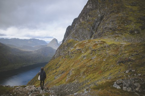 young man hiking on mountain in Norway