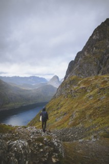 young man hiking on mountain in Norway