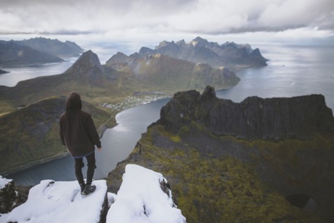 young man hiking on mountain in Norway