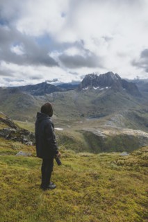 young man hiking on mountain in Norway