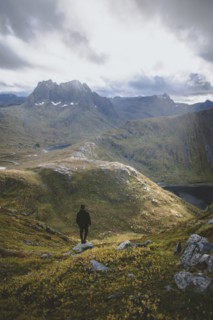 young man hiking on mountain in Norway