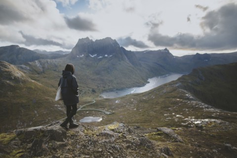 young man hiking on mountain in Norway