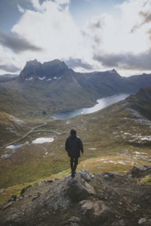 young man hiking on mountain in Norway