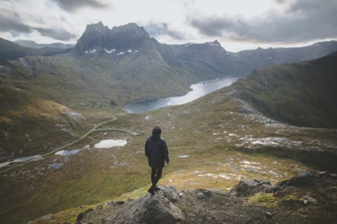 young man hiking on mountain in Norway