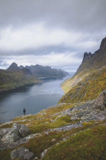 young man hiking on mountain in Norway