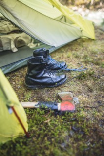 Boots and hatchet by tent