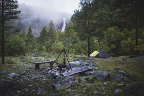 Cooking pot on tripod above campfire