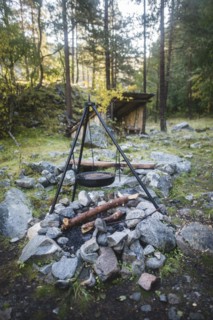 Cooking pot on tripod above campfire